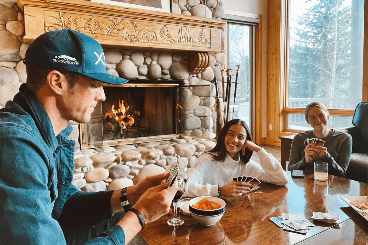 Ggather in front of a stone fireplace in AvantStay vacation rental in Park City