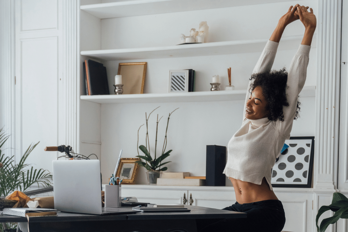 woman doing exercises from her desk