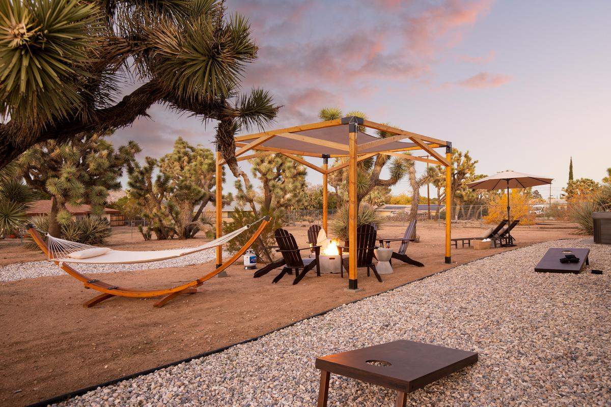 Joshua Tree vacation rental backyard with firepit and cornhole 