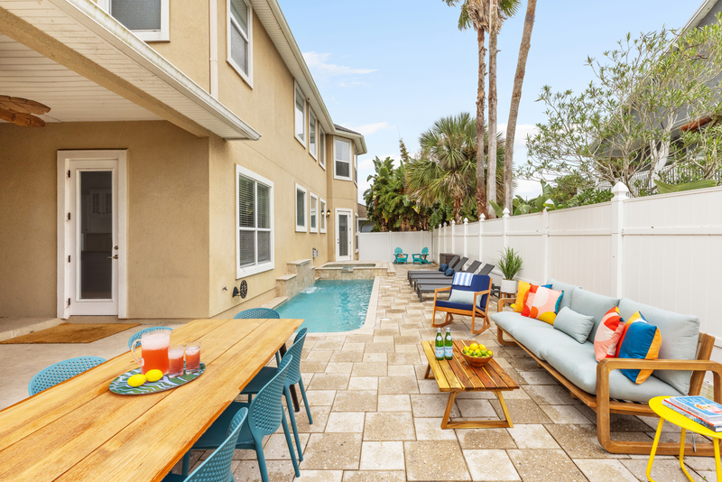 backyard with blue swimming pool and twin palm trees making it the best st augustine airbnb
