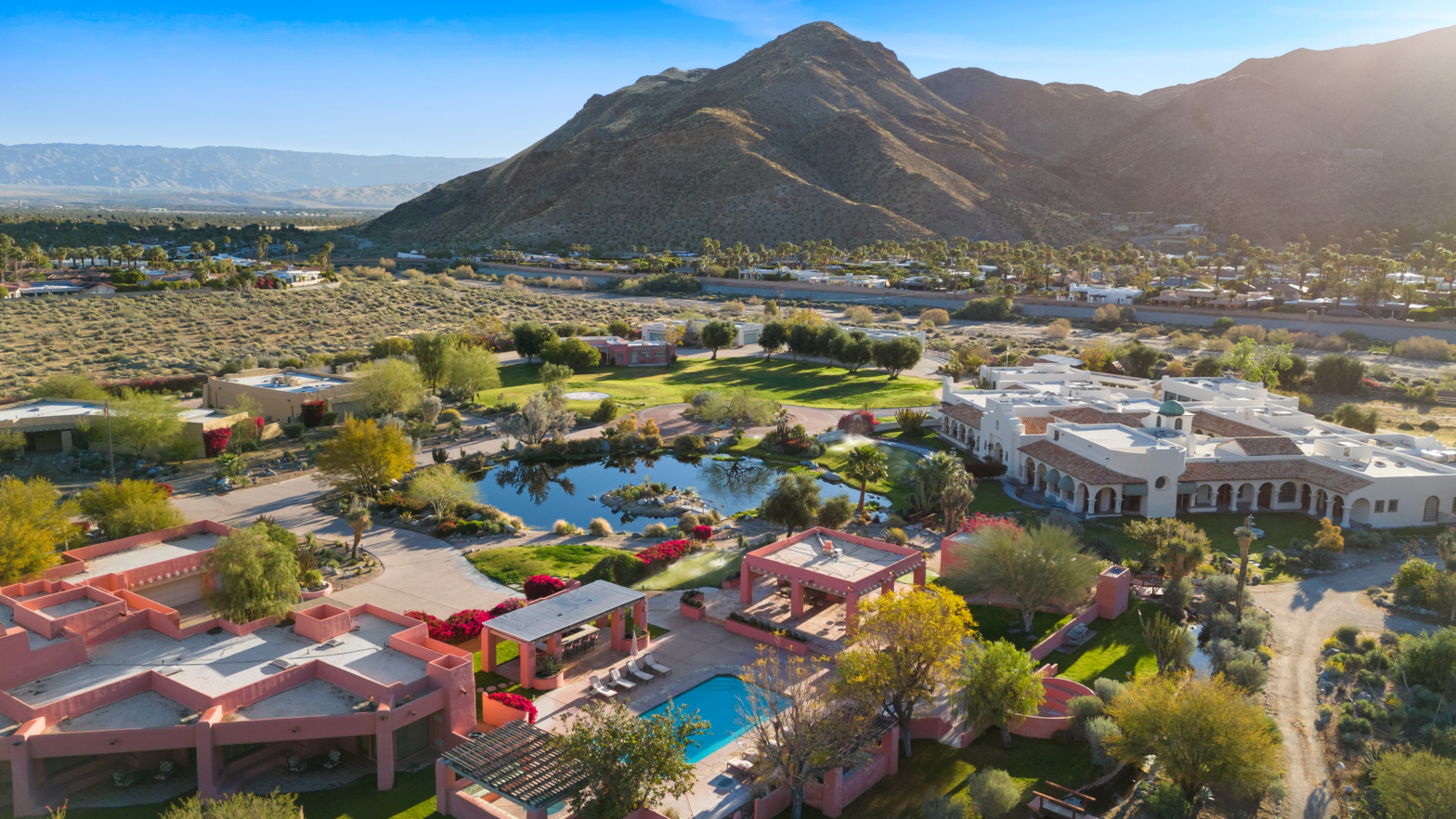 overview of a big compound of 3 spanish casa with a pond in between