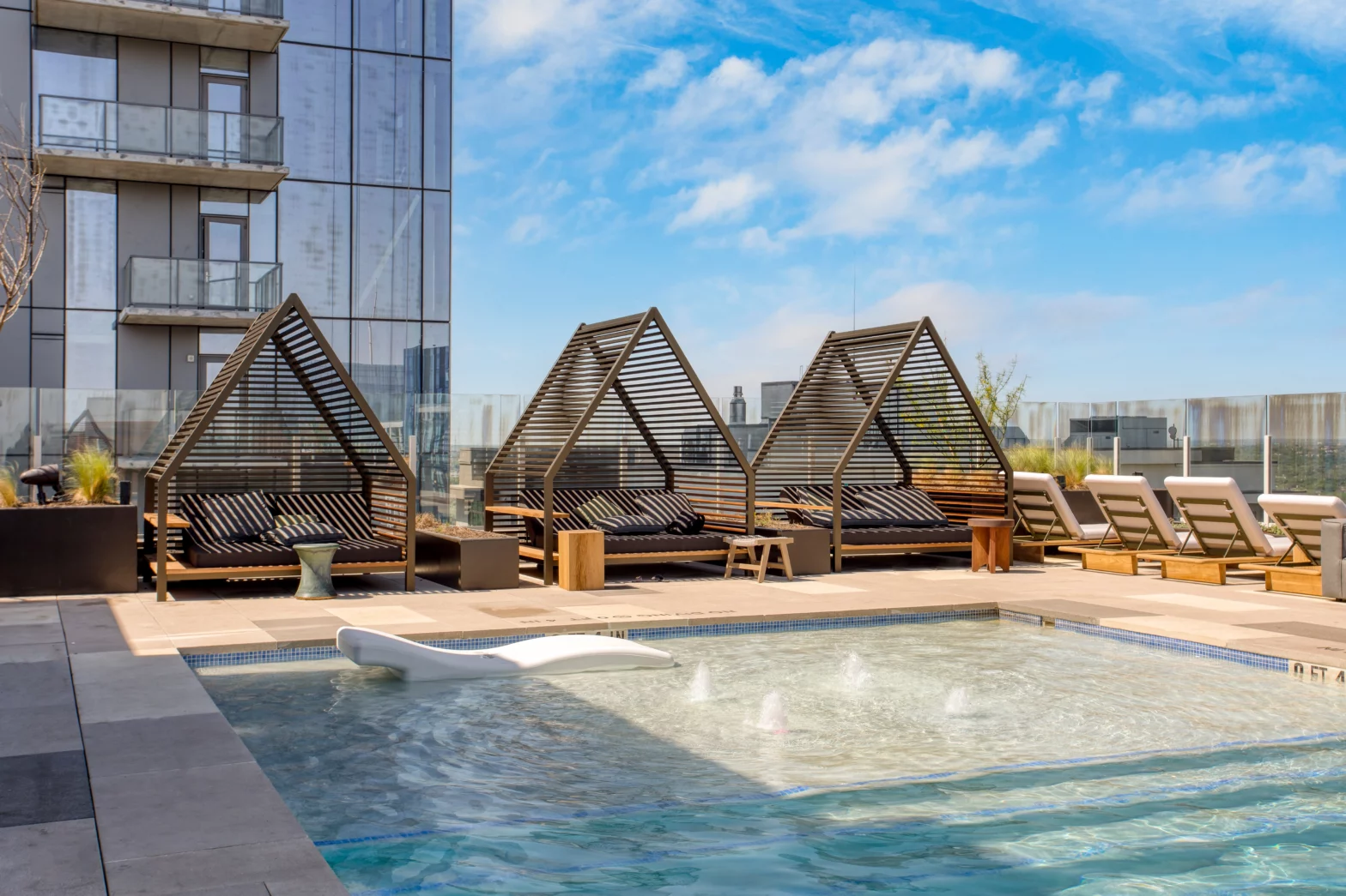 3 triangle gondola roofs along the rooftop aqua blue swimming pool